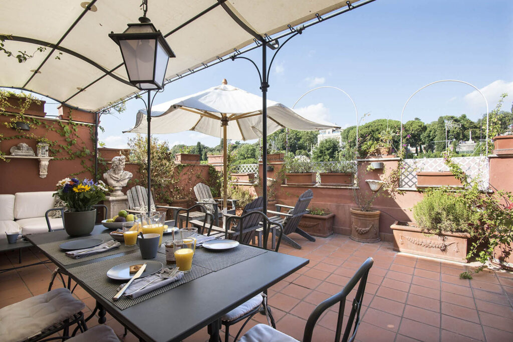 Pic of a breakfast table set on a terrace above the spanish steps in rome