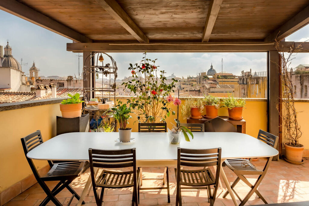 Photo of a dinging table for six on a terrace rooftop in rome, italy
